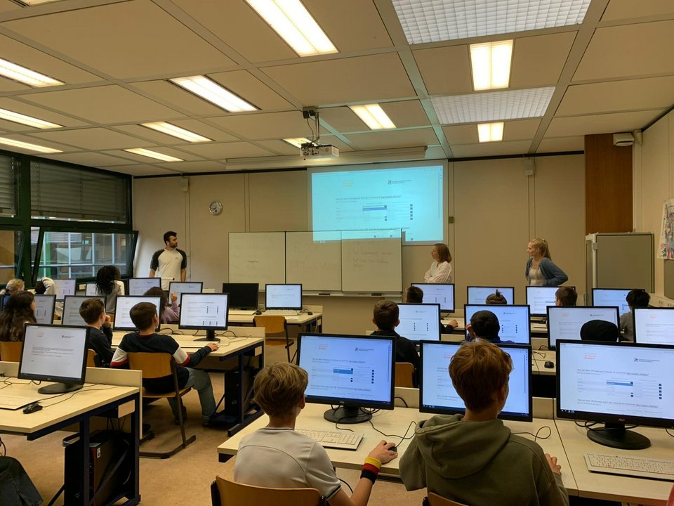 Computer lab with students and project staff: Data collection at educational institutions