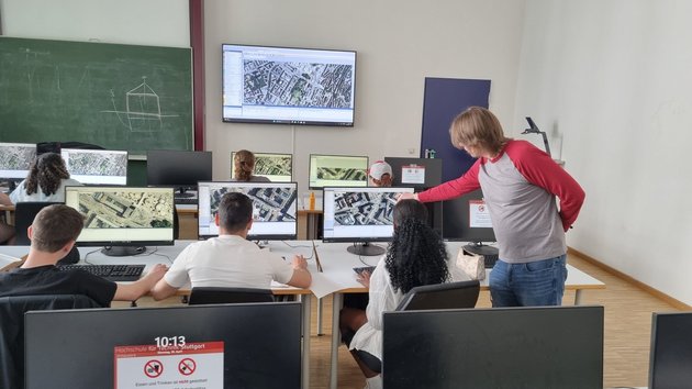 Studierende in einem Raum mit vielen Monitoren